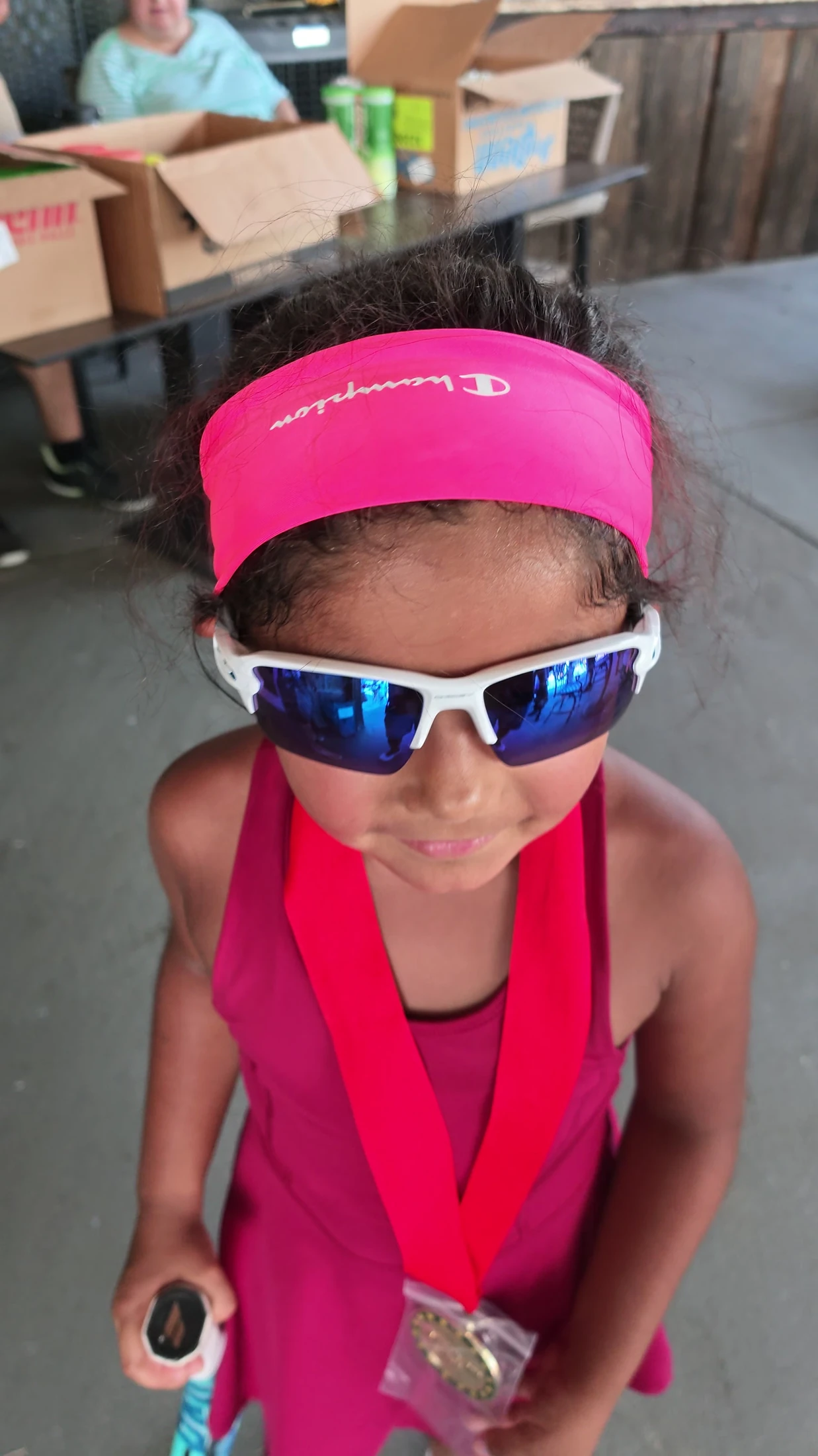 Penny wearing her visor and tournament lanyard